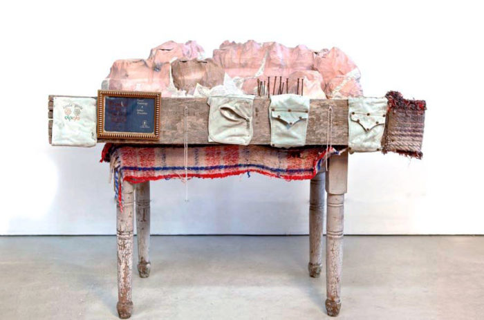 <p>Guillermo Galindo. <em>Soundscape (Paisaje sonoro)</em>, 2014. Hollow wood, rusty nails, clothing, Bible. Mountain sculpture: 27 × 51 × 12 in. (68.6 × 129.5 × 30.5 cm). Table: 20 × 30 × 40 in. (50.8 × 76.2 × 101.6 cm). Art Bridges. Photo: Courtesy of the artist, photo by Richard Misrach.</p>
